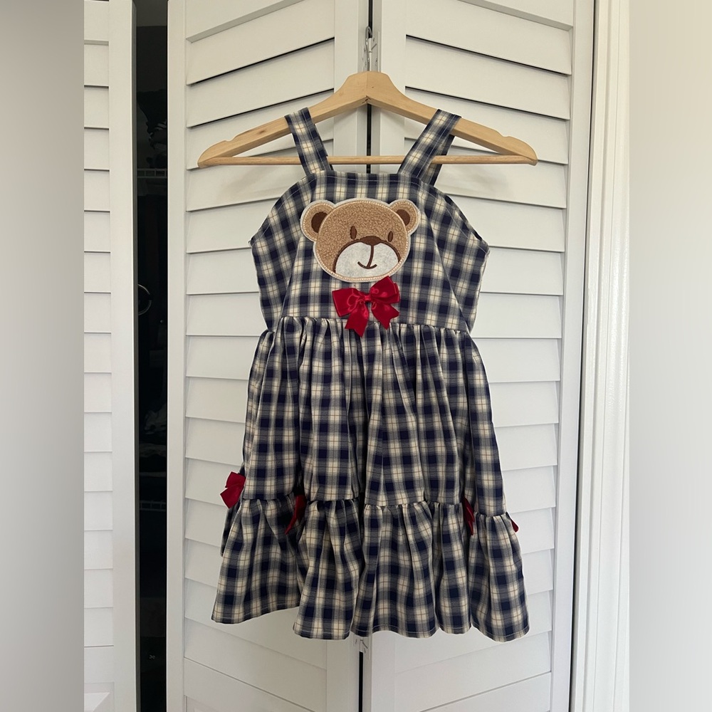Little girl plaid skirt bow datelined blue and white .